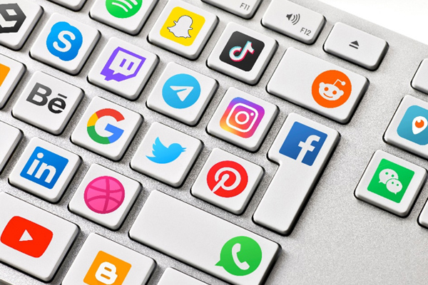 A photo of a keyboard with social media logos