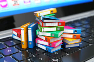 A photo of binders on a keyboard, used for Why Should Federal Agencies Notify NARA About "Unauthorized Disposition" in Government Records?