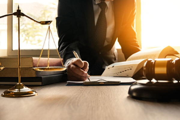 Image of a person signing in a law firm