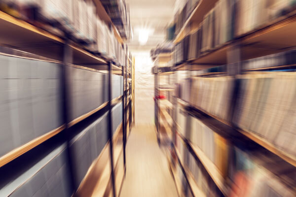 Blurred image of an archive with shelves of documents