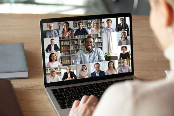 Image of a person on a laptop in a virtual meeting with many people